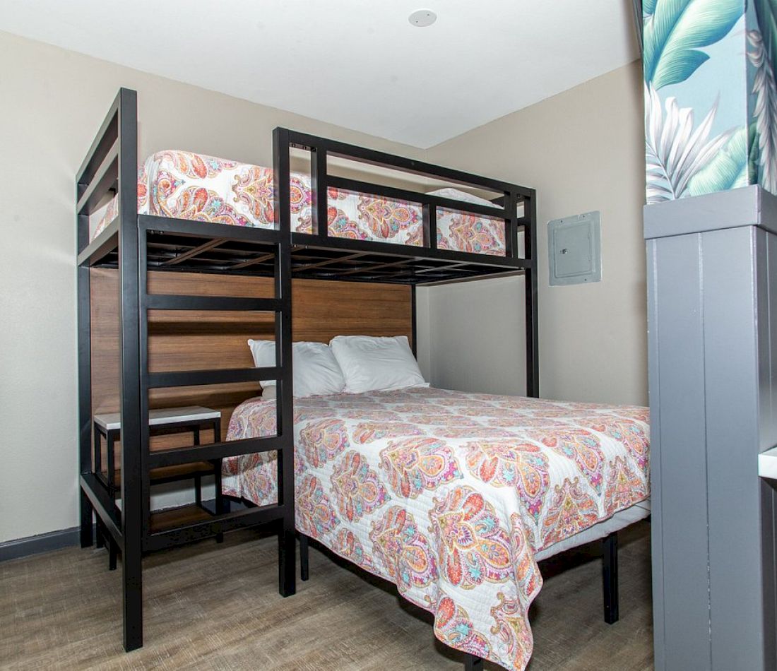 A hotel room with bunk beds and a single bed